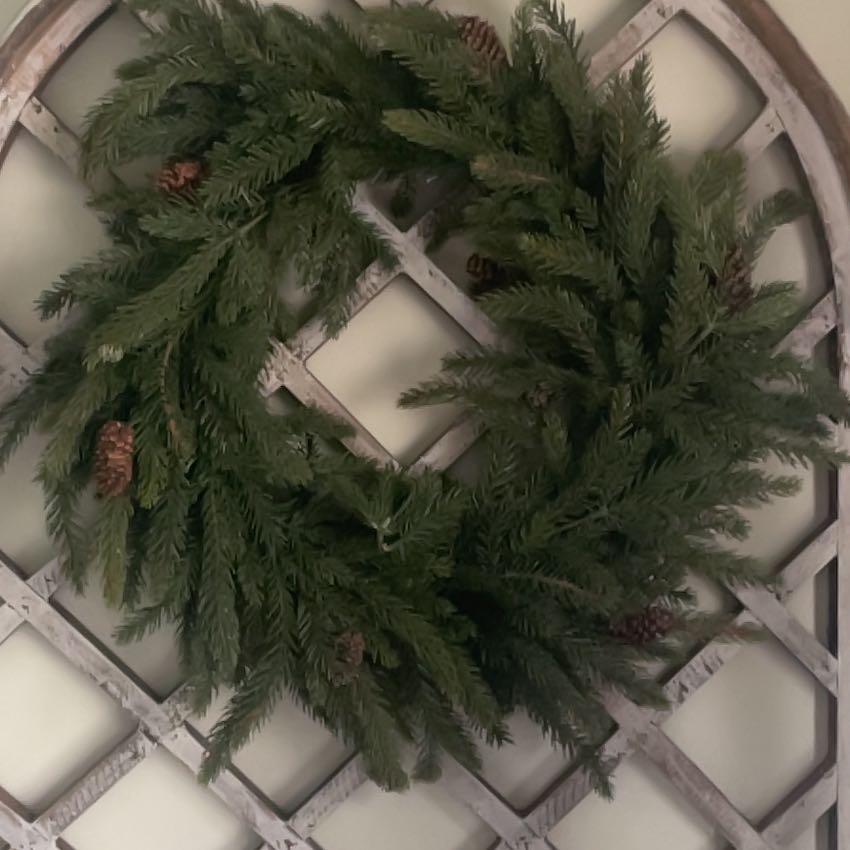 Wreath made from Japanese Cedar branches on a lattice background.
